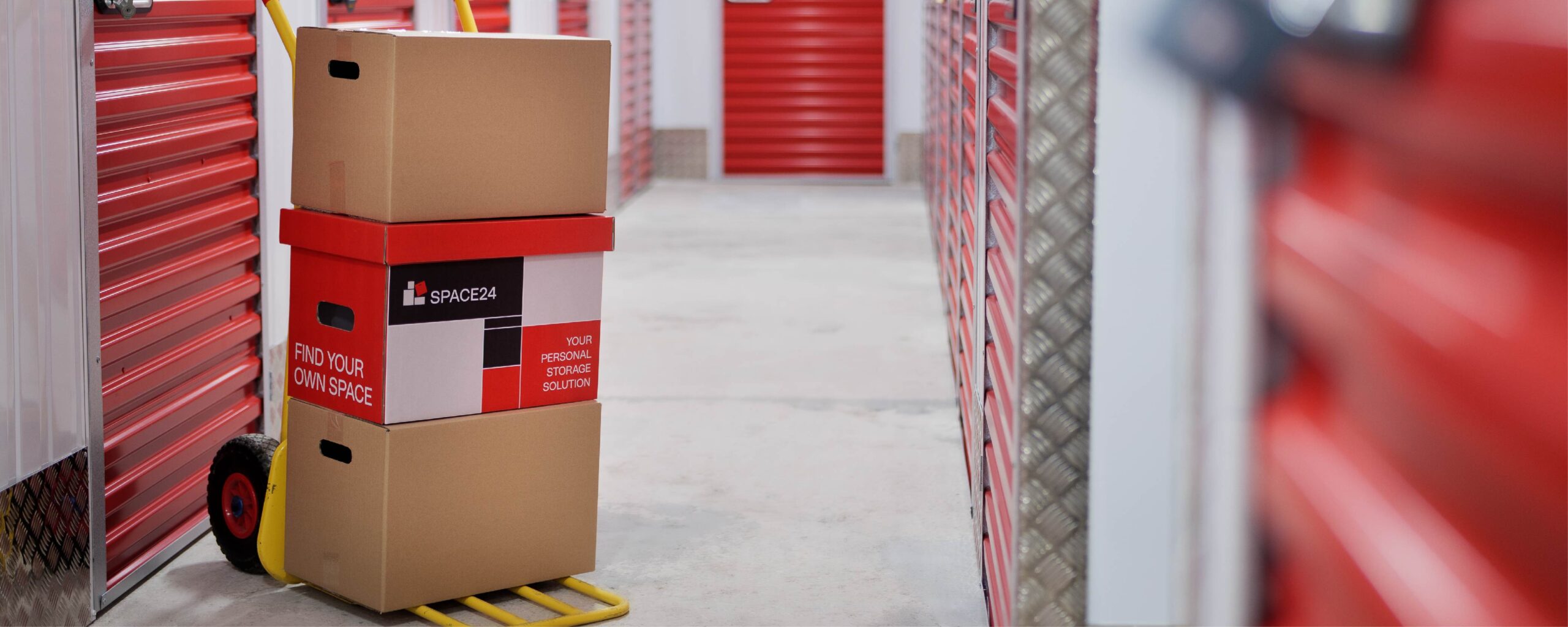 An e-commerce business stacks pallets of stock and business equipment in a storage unit