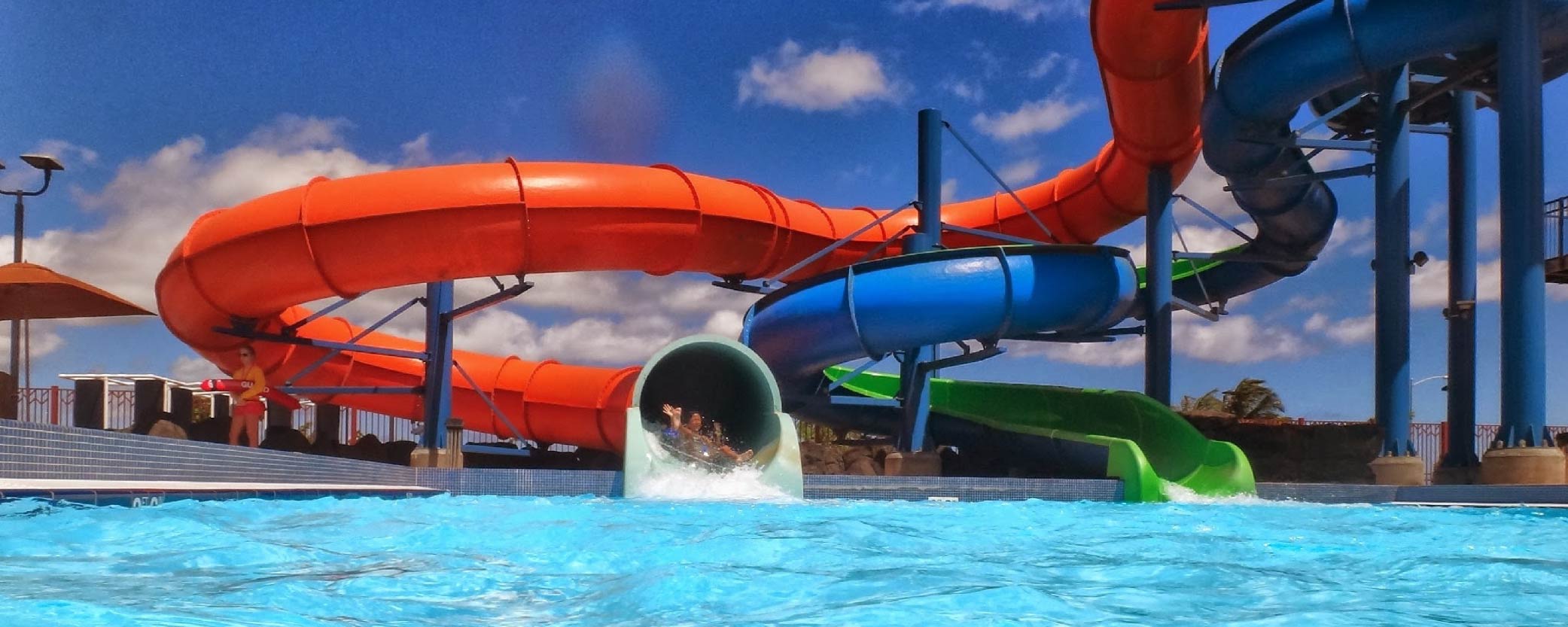 A young child slides down a waterslide